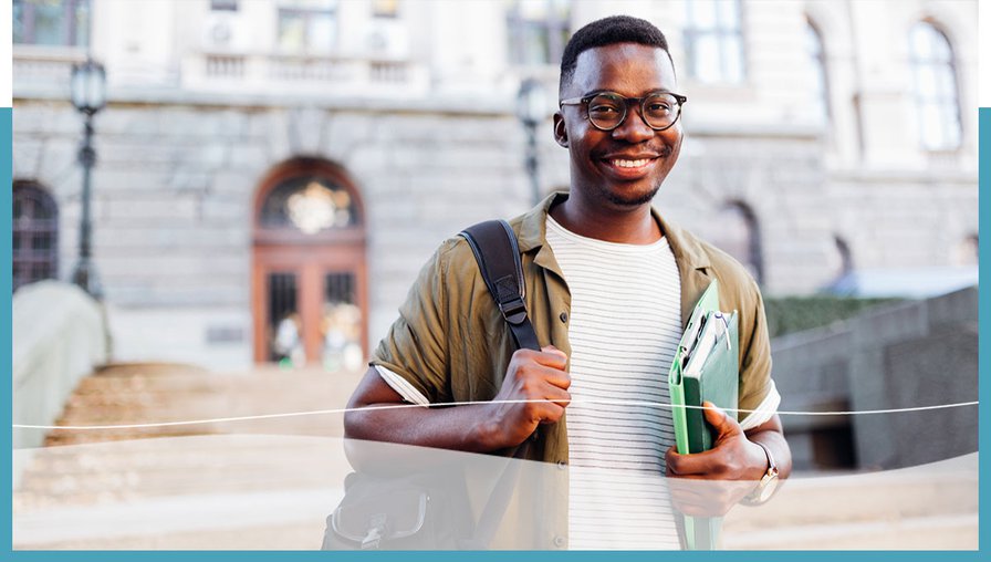student smiling at camera infront of university buidling