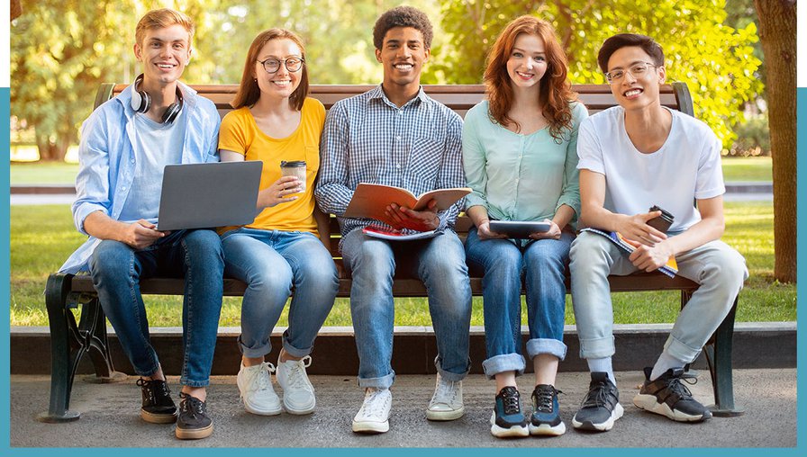 group of young adults sitting on bench smiling at