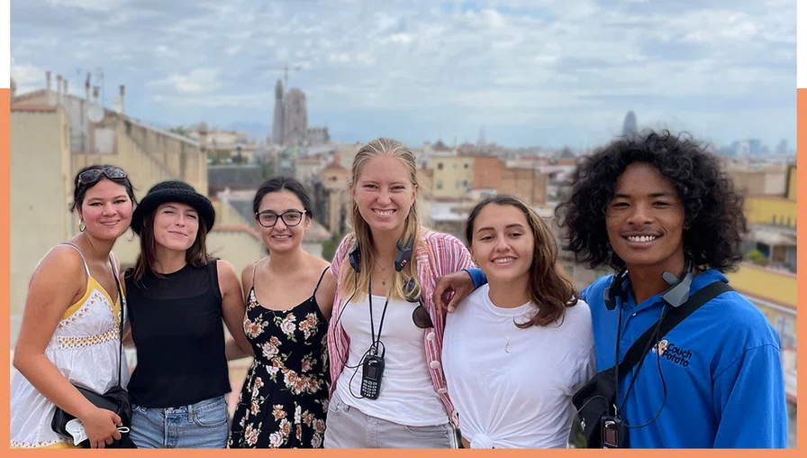group of students smiling for camera with Barcelona cityscape in background
